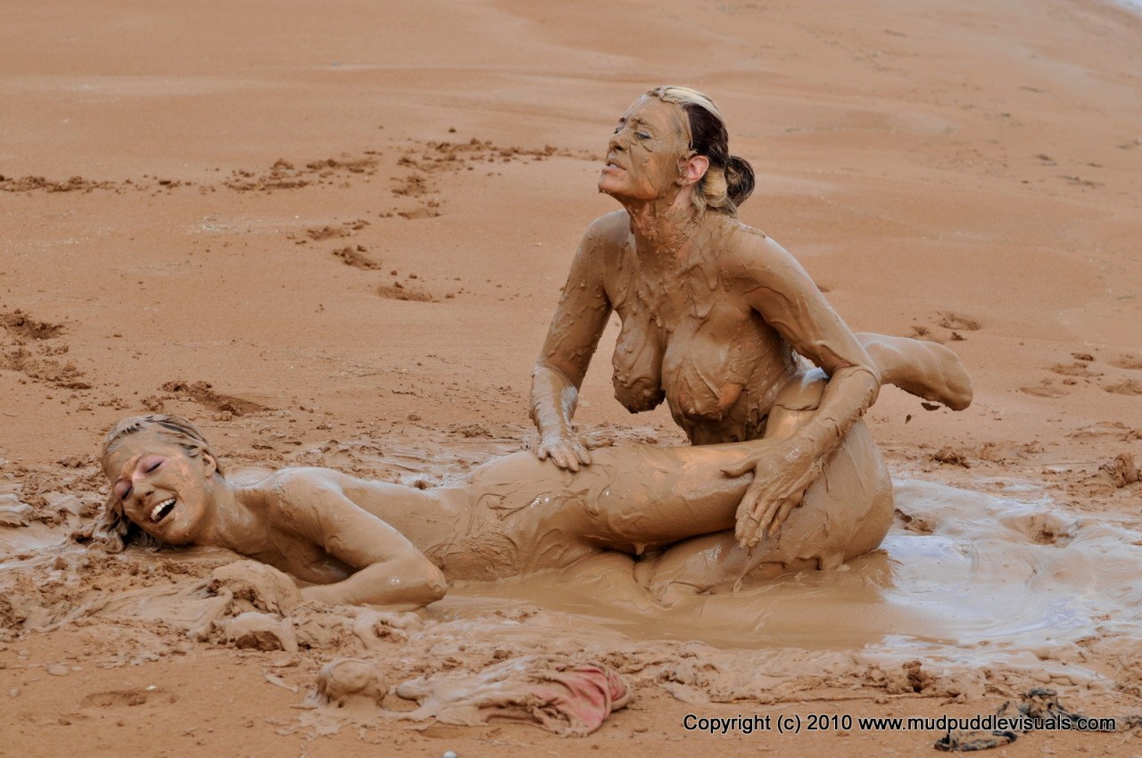 Naked women in mud